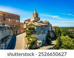 View of Venasque village with old church Notre Dame de Vie to landscape of Luberons, Provence, France. Beautiful Church and houses in the town of Venasque, Provence, France.