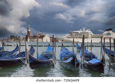 View Of Venice, Gondolas On Pier And A Cruise Ship