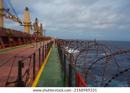 View of the vessel hardening on board ships using razor wire and wire fencing, to stop pirates from boarding the ship