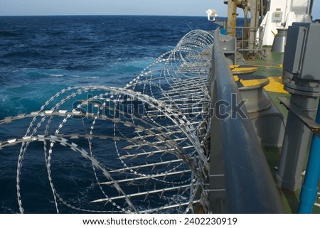 View of the vessel hardening on board ships using razor wire and spikes, to stop pirates from boarding the ship. These ship protection measures are employed when the ship passes high risk areas