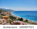 view of the village of Santa Teresa di Riva on the Ionic Coast of SIciliana and the Strait of Messina in the background