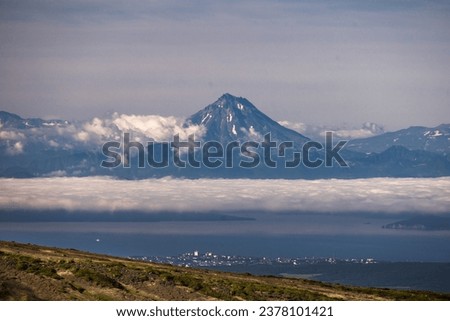 View of the Vilyuchinsky volcano from Avachinskaya Mountain. Natural attractions of the Kamchatka peninsula. Travel and tourism in Siberia and the Russian Far East. Beautiful natural background