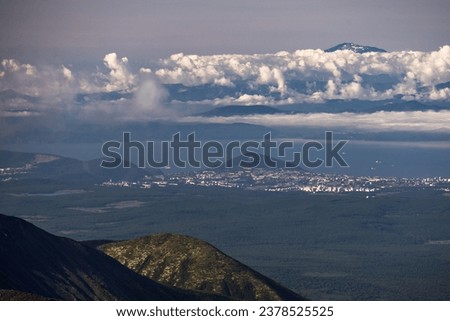 View of the Vilyuchinsky volcano from Avachinskaya Mountain. Natural attractions of the Kamchatka peninsula. Travel and tourism in Siberia and the Russian Far East. Beautiful natural background