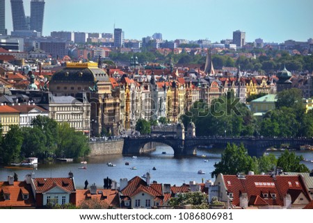 View of the Vltava river with boats, the Legion bridge, the National theatre in Prague, Czech Republic. Beautiful spring cityscape.