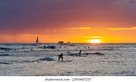 View from Waikiki beach at beautiful sunset with silhouettes of swimmers and surfers, Honolulu, Oahu, Hawaii, USA - Powered by Shutterstock