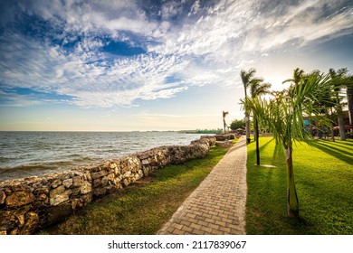 View of the walkway in a park on the shore of Lake Victoria in Entebbe, Uganda, during the last rays of sunlight in the evening