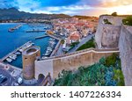 View from the walls of the citadel of Calvi on the old town with historic buildings at evening sunset.Bay with yachts and boats. Luxurious marina and very popular tourist destination. Corsica, France
