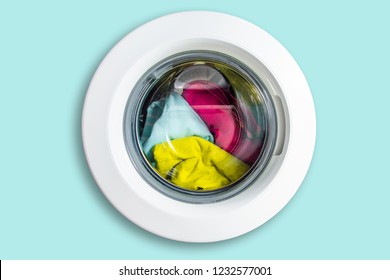 View of the washing machine from the front isolated. Door from the washing machine, with a drum with clothes. The concept of washing and taking care of the cleanliness of clothes.