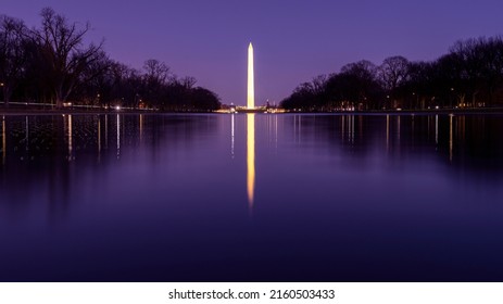 View of Washington Monument on the Reflecting Pool in Washington, DC, USA at dawn. Summer.