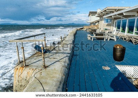 A view of waterfront homes with waves rolling in at Oak Harbor, Washington.