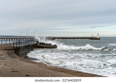 View of waves crashing at the harbour wall in Amble, Northumberland, UK - Powered by Shutterstock