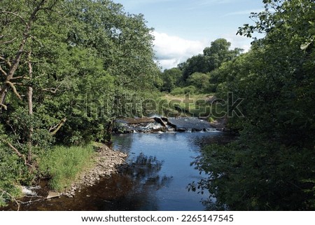 View of the weir at Endrick Water from the West Highland Way and John Muir Way walking trails at Gartness Bridge, Stirlingshire, Scotland.