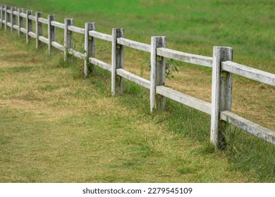 view of white fence in farm field  