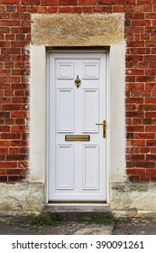 View Of A White Front Door Of A Red Brick English Town House