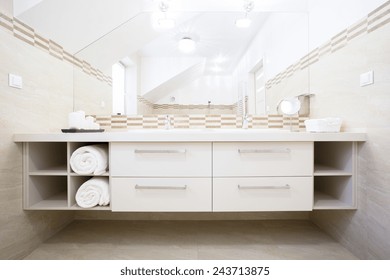 View of white furniture in bright bathroom