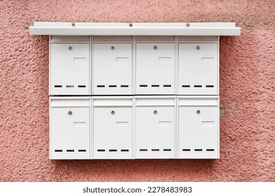 View of white mailboxes on building wall