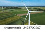 view of wind turbine among green fields and blue sky