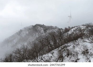 View of the wind turbines on the covered mountain in winter - Powered by Shutterstock