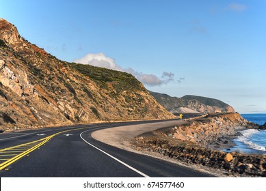 View of winding Pacific Coast highway PCH in coastal southern California and the Pacific ocean.