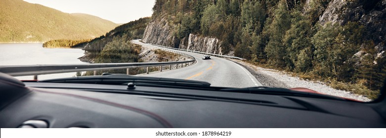 A View Of A Winding Road And A Super Car From A Running Sports Car