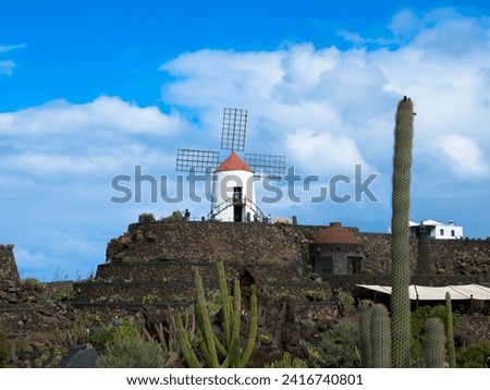 View of windmill at Jardin de Cactus, famous botanical cactus garden 
near Guatiza in Lanzarote island. Popular sightseeing in Canary Islands.