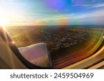 View from the window of an airplane as it takes off at sunrise. Plane flying low, taking off from the city of Campo Grande - MS, Brazil.
