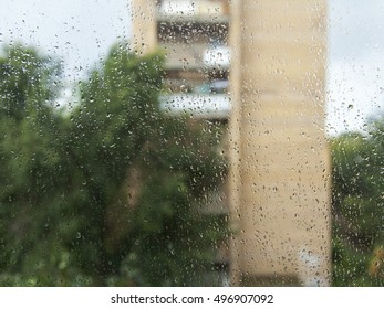 View from the window during a rain. Focus on drops on glass.