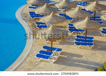 The view from the window of the hotel in Egypt to the pool, sun umbrellas and the Red Sea