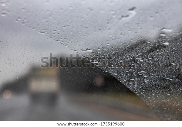 the\
view from the window of a moving car in rainy weather. Defocused\
track and cars. Speed in poor visibility\
conditions.