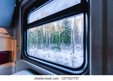 View of the window of a moving passenger train. The camera is very close to the window.