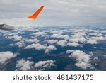 The view from the window, the wing of an airplane, clouds, earth