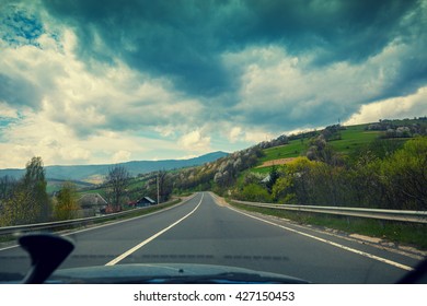 View From Windscreen. Driving A Car On Mountain Road