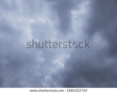 View of the windy atmosphere and cloudy clouds marching in the darkening sky signaled the day of heavy rain. Selective focus with blurred and noice effect.