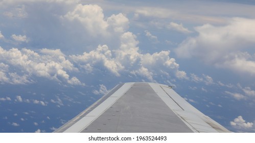 the view from the wing of the plane to the cloudy sky