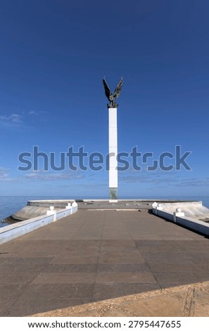 view of winged angle statue in campeche mexico (waterfront sign letters coast malecon boardwalk) beautiful colonial city on gulf coastal town travel tourism colorful sculpture