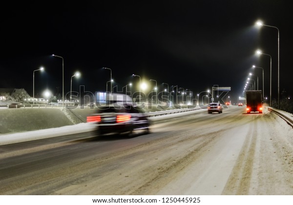 view of the winter snow-covered road with fires from\
the rushing cars
