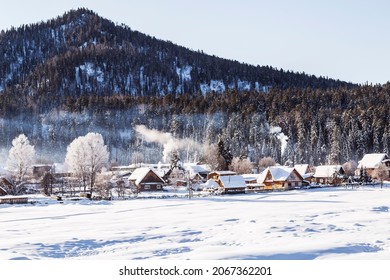 View of the winter  the village Iogach against the background of forested mountains. Altai Republic, Russia - Shutterstock ID 2067362201