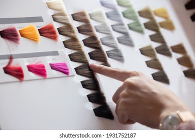 View Of Woman Choosing Color From The Hair Color Chart  For Hair Dye Concept