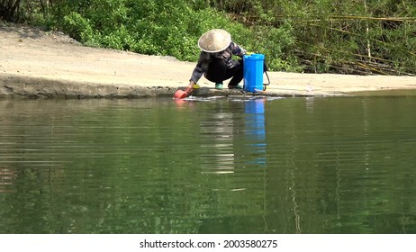 View Of Woman Collecting Drinking Water From River Located In China Near Village Often Women Are Responsible For Getting It When Its Not On Premises Which Can Be Bad For Sanitation And Hygiene 4k