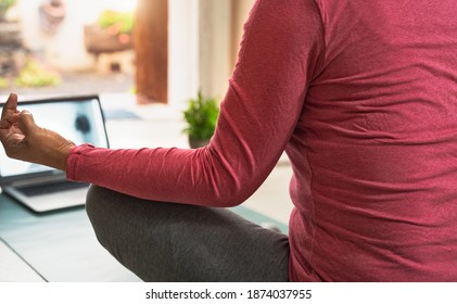 View Of Woman Doing Yoga Virtual Fitness Class With Laptop At Home - E-learning And People Wellness Lifestyle Concept