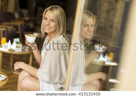 View of the woman holding a cup of coffee