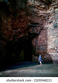 View Of Woman Tourist At Littoral Sea Cave Entrance