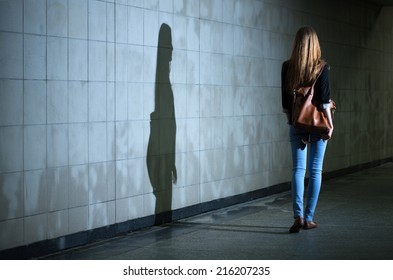 View of woman walking alone at night