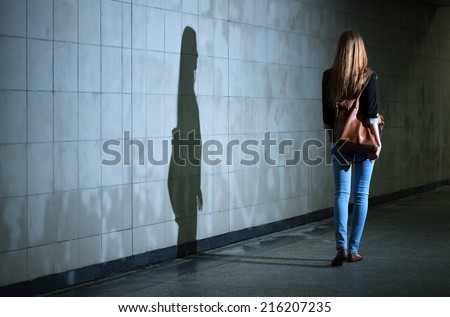 View of woman walking alone at night