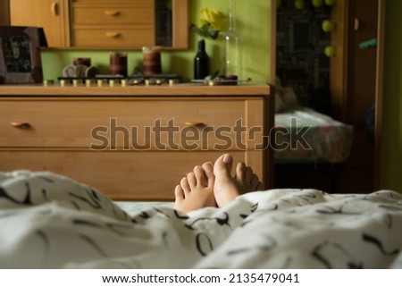 View of a woman's feet, from bed in the morning when waking up