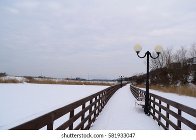 View of the wooden boardwalk on the lake in the village of AMBER in the winter