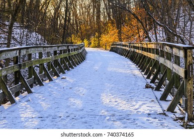 View Of A Wooden Bridge Covered With Snow; Sun Lights The End Of The Bridge; Winter In Missouri, Midwest