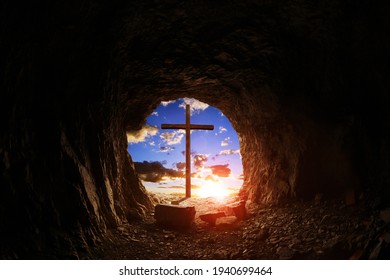 View of wooden cross at sunset from cave.