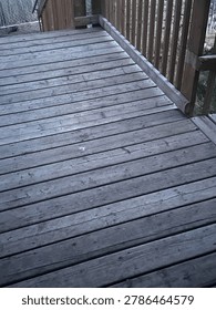 View of wooden deck structure showcasing outdoor residential construction, timber surface textures, and backyard exterior design