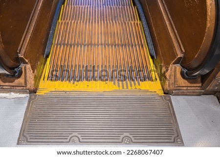 View of wooden escalator stairs down in department store. NY. USA.